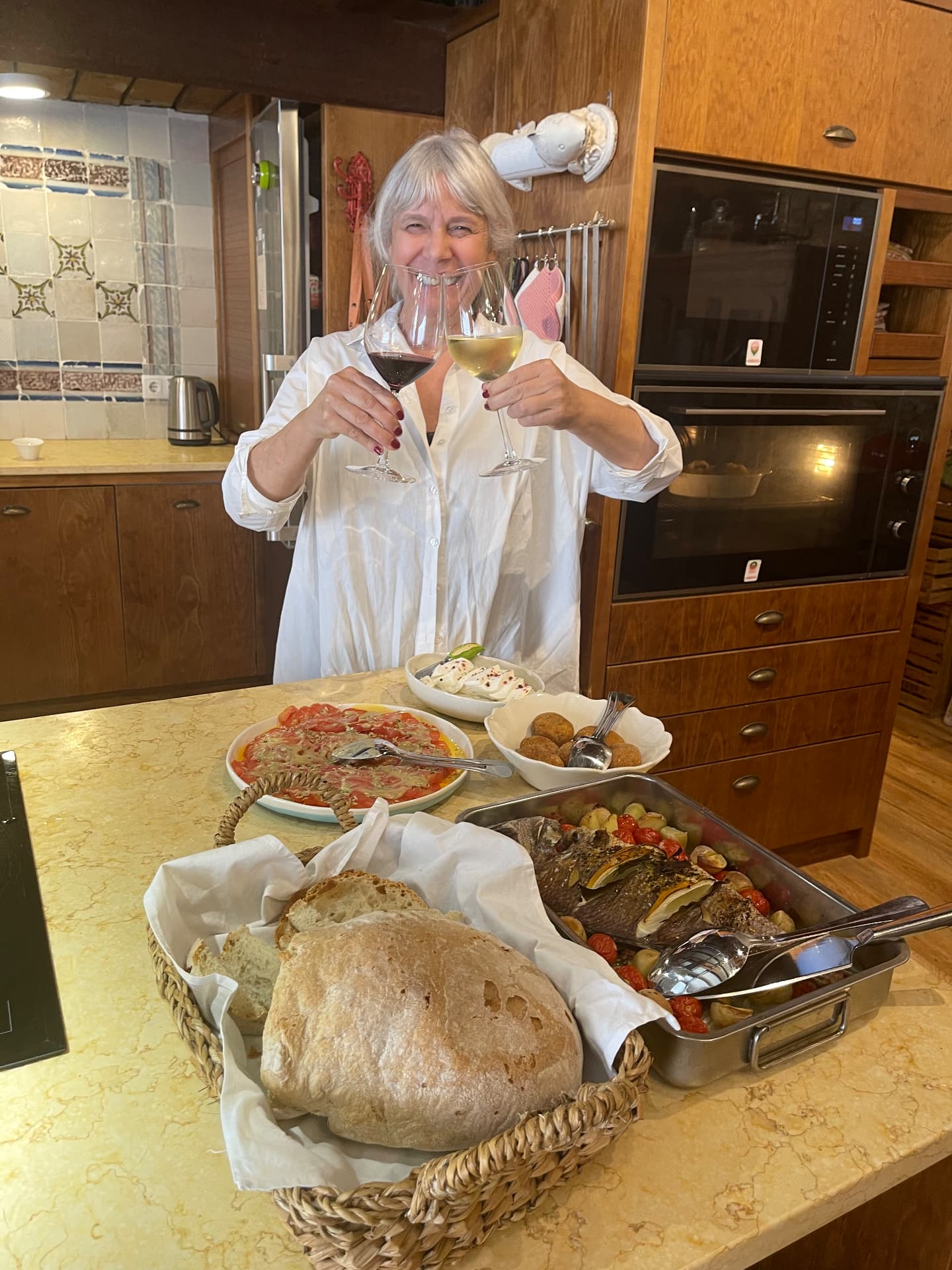A home-cooked Portuguese meal and local wine shared around a table in Portugal