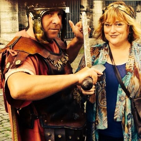 Jamie Leigh with a costumed Roman centurion beside the Colosseum in Rome, Italy